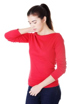 Young woman holding hand on her neck. Neck pain concept