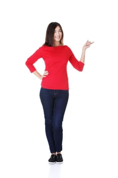 Happy , excited young woman pointing on copy space, isolated on white