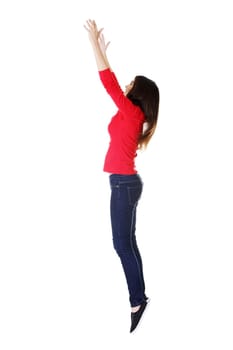 Teen girl jumping in air trying to catch something. Isolate don white.