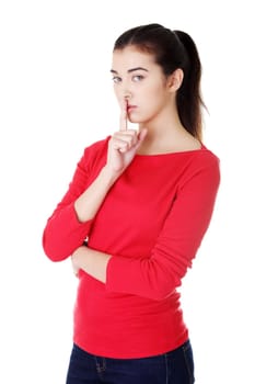 Woman making a keep it quiet gesture , isolated on white