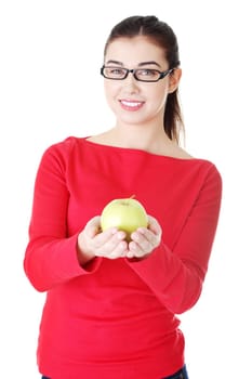 Young woman holding green fresh apple in hand, isolated over white background
