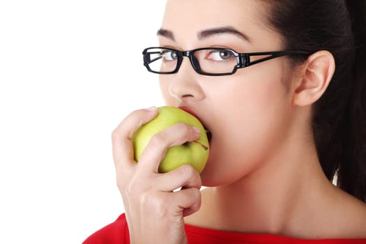 Attractive young woman eating green apple. Isolated