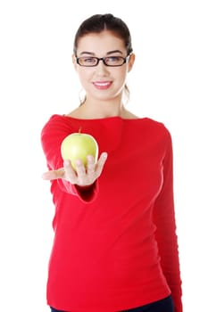 Young woman with green fresh apple, isolated over white background