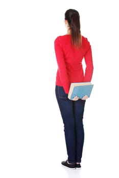 Back view of young student woman holding an old book. Isolated over white background.