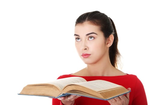 Young woman reading an old book, isolated on white