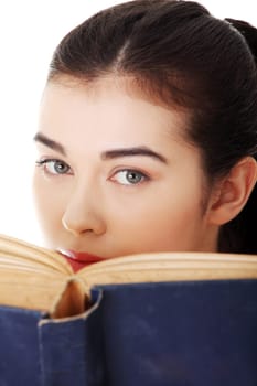 Young woman reading an old book, isolated on white