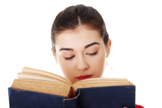 Young woman reading an old book, isolated on white