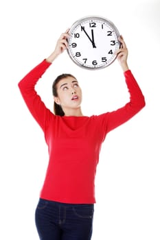 Shocked woman holding office clock, isolated on white bacvkground