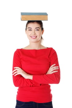 Young caucasian woman (student) with book on her head