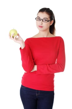 Young woman with green fresh apple, isolated over white background