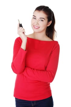 Happy woman with a car key. Isolated on white.