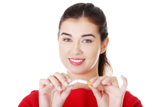 Young woman with broken cigarette. Stop smoking concept.