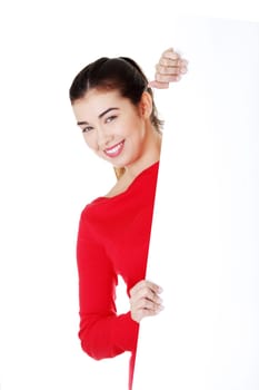 Portrait young happy woman with blank board isolated on white