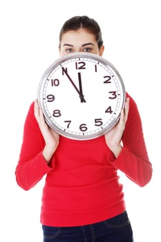 Shocked woman holding office clock, isolated on white bacvkground