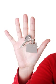 Hand holding a house key. Isolated on white background.