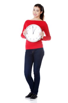 Happy young woman holding office clock, isolated on white background