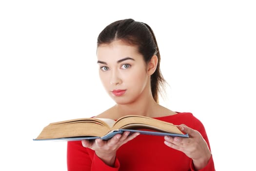 Young woman reading an old book, isolated on white