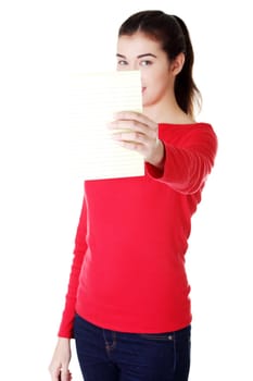Young happy student woman showing blank notepad, isolated on white background