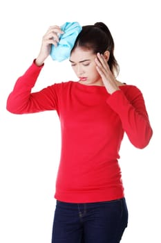 Woman with ice bag for headaches and migraines , isolated on white