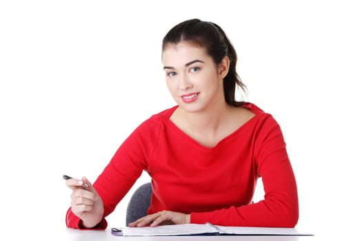 Adult student woman learnig at the desk, isolated on white background