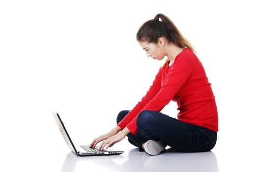 Happy young woman using her laptop, isolated on white.