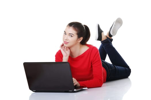 Happy young woman using her laptop, isolated on white.