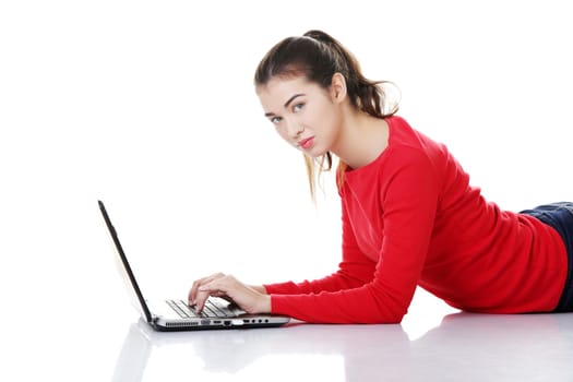 Happy young woman using her laptop, isolated on white.