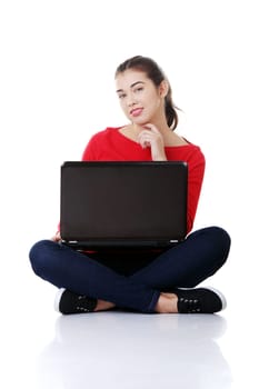 Happy young woman using her laptop, isolated on white.