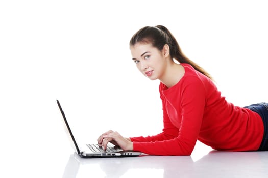 Happy young woman using her laptop, isolated on white.