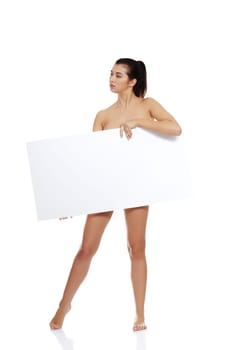 Sexy naked brunette holding empty board , isolated on white.