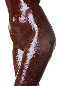 Naked female body covered with chocolate, isolated on white