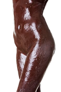 Naked female body covered with chocolate, isolated on white
