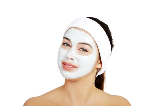 Beautiful woman with clay facial mask, isolated on white
