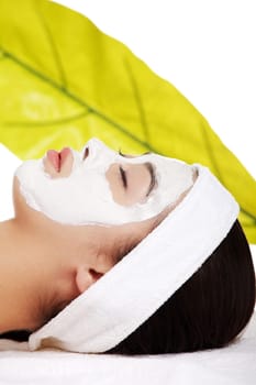 Beautiful woman with clay facial mask, isolated on white