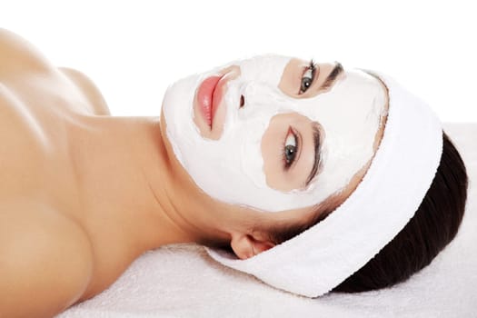 Beautiful woman with clay facial mask, isolated on white
