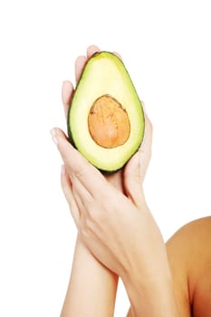 Pretty female hands holding fresh avocado, isolated on white