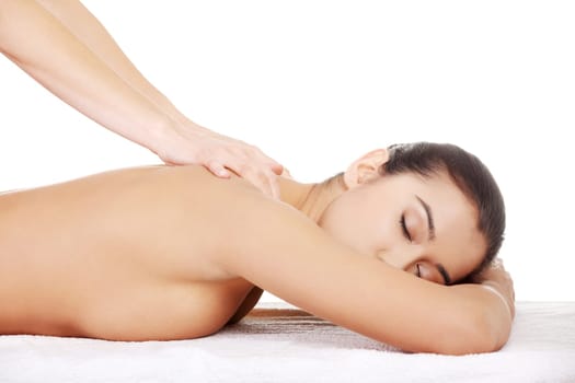 Pretty young woman relaxing beeing massaged in spa saloon
