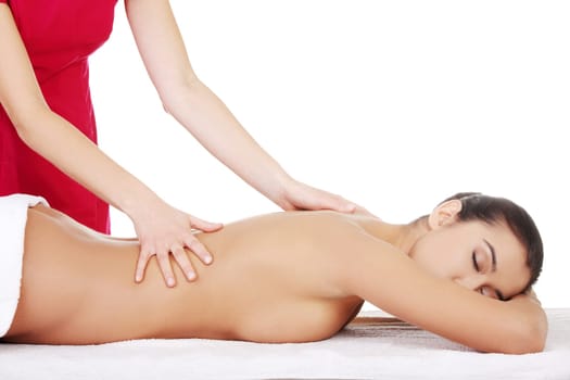 Pretty young woman relaxing beeing massaged in spa saloon