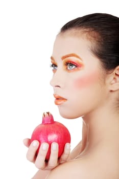 Portrait of young beautiful woman with pomegranates in her hands, on white background