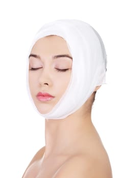Portrait of beautiful young female face with bandage - beauty treatment plastic surgery