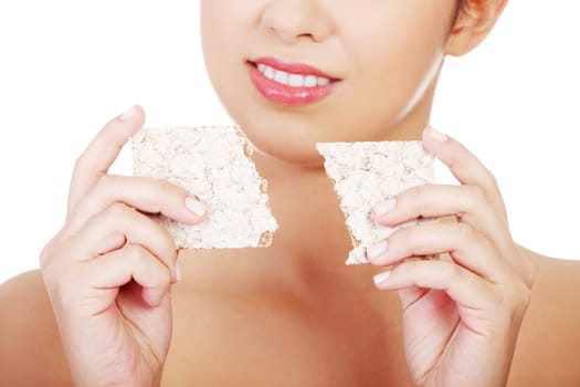 Young pretty woman eating healthy rye cracker bread