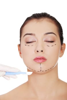 Cosmetic surgery concept. Female face in background of scalpel.