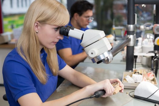 Dental technician at work in a dental laboratory or dental workshop