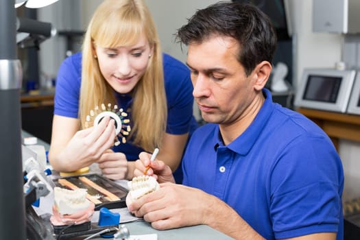 Dental technician at work in a dental laboratory or dental workshop