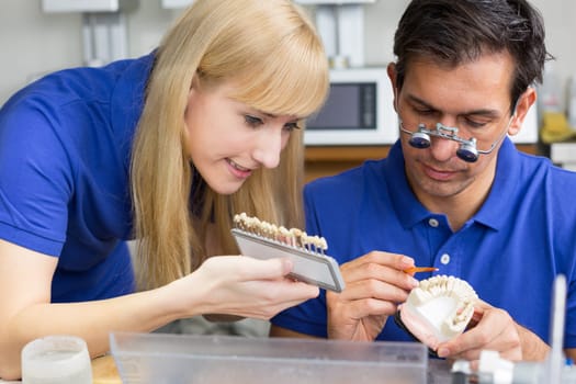Dental technician at work in a dental laboratory or dental workshop