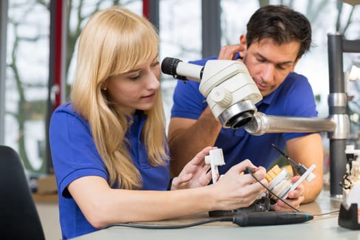 Dental technician at work in a dental laboratory or dental workshop