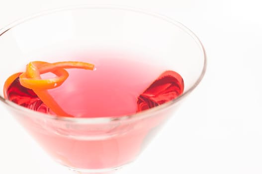Pink Martini Cocktail made from Gin, Vermouth and a dash of Red Curacao garnished with orange twist