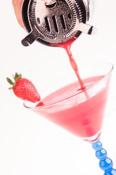 Pouring a Strawberry Daiquiri into a cocktail glass