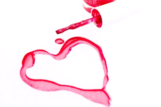 Nail polish with heart shape symbol over white background