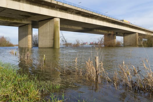 high water under a bridge, crossing the IJssel river in Deventer, Netherlands